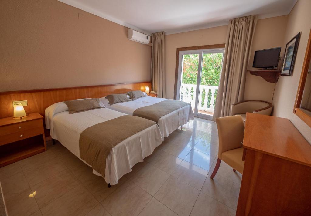 Postel nebo postele na pokoji v ubytování Hostal Gallet
