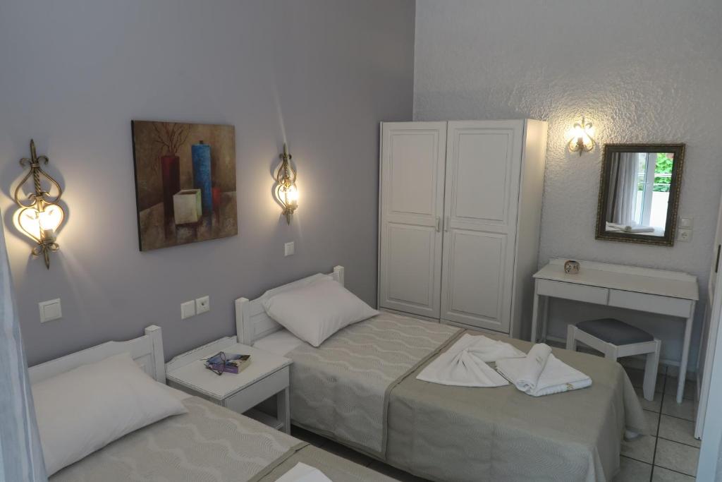 Postel nebo postele na pokoji v ubytování Maria Suites