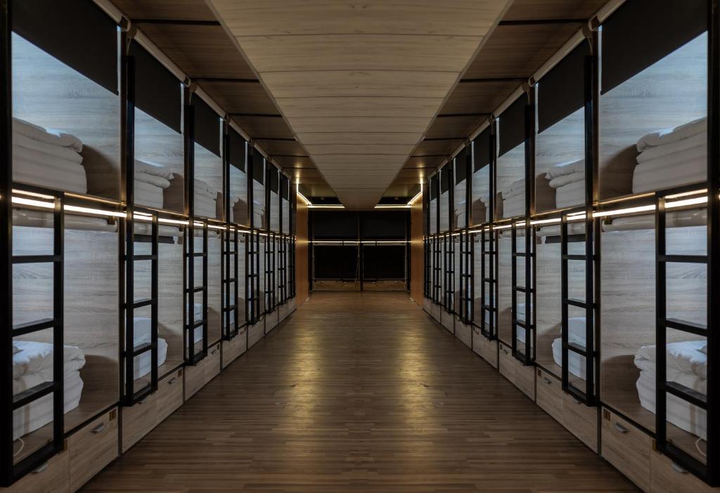 a hallway in a building with windows and a long corridor at Hostel Inbox in Skopje