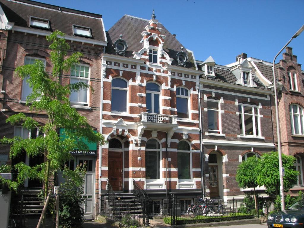 a large brick building with a clock on the front of it at Bed & Breakfast Pluweel in Nijmegen