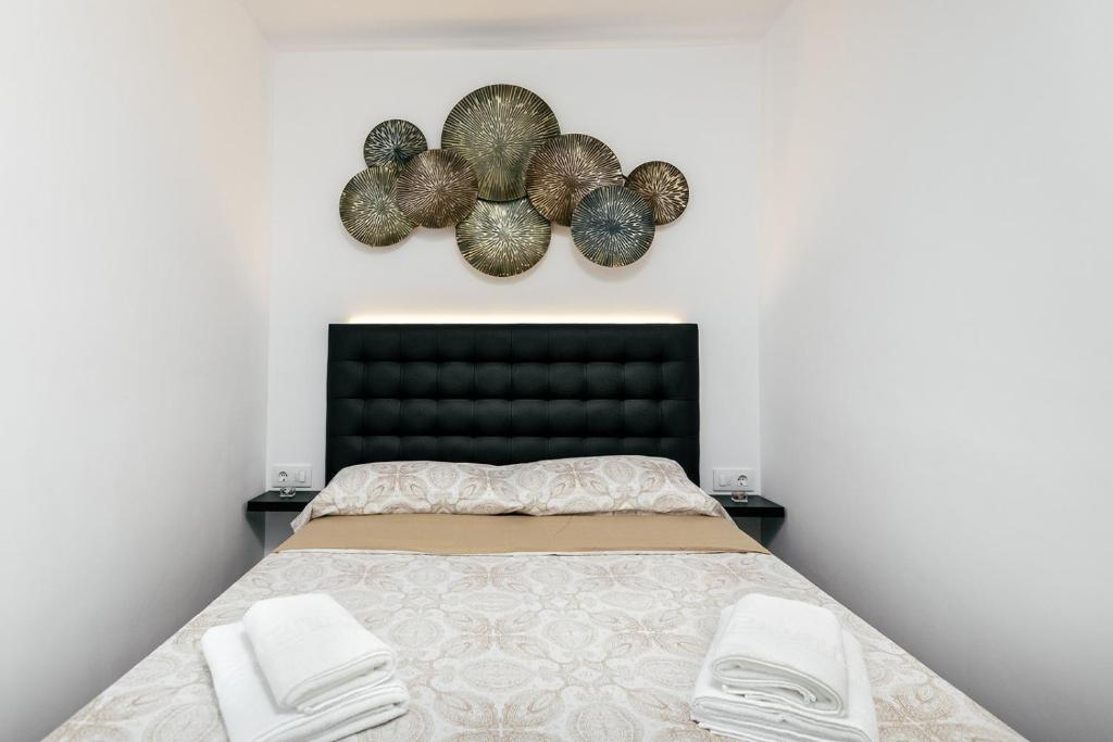 Postel nebo postele na pokoji v ubytování Empuria Beach D-Luxe