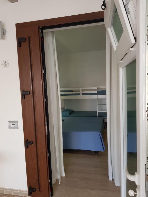 a door leading into a bedroom with a bed at Hotel Perla Gaia in San Vito lo Capo