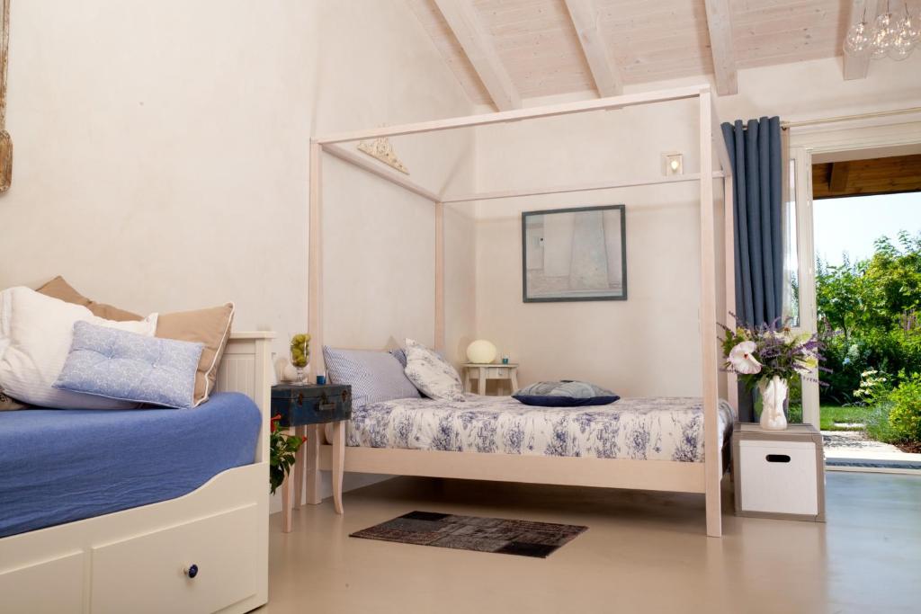 a bedroom with two beds and a mirror at Boccadibacco in San Pietro in Cariano