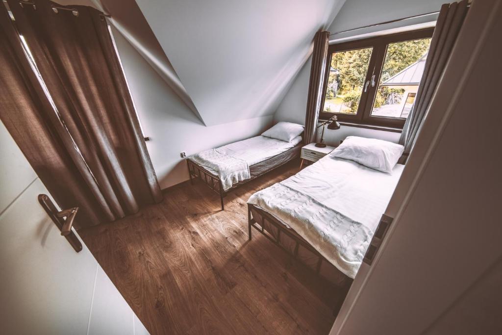 Posteľ alebo postele v izbe v ubytovaní ARKA HOUSE DOMEK WIDOKOWY