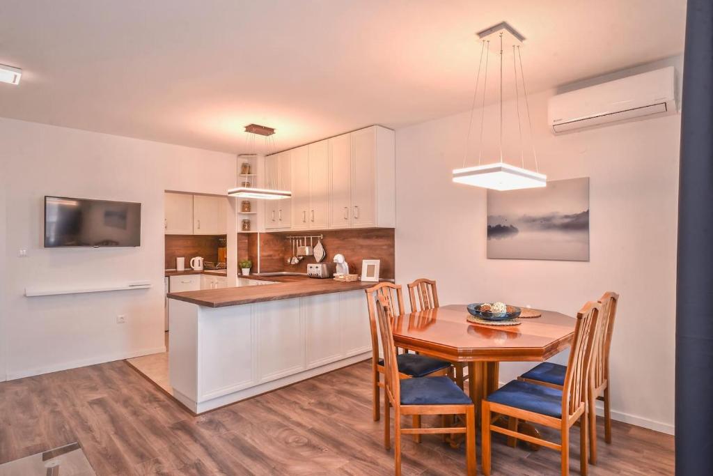 a kitchen and dining room with a table and chairs at South Park, Vitosha View, 2-BDR, 2-BTHR Apartment in Sofia