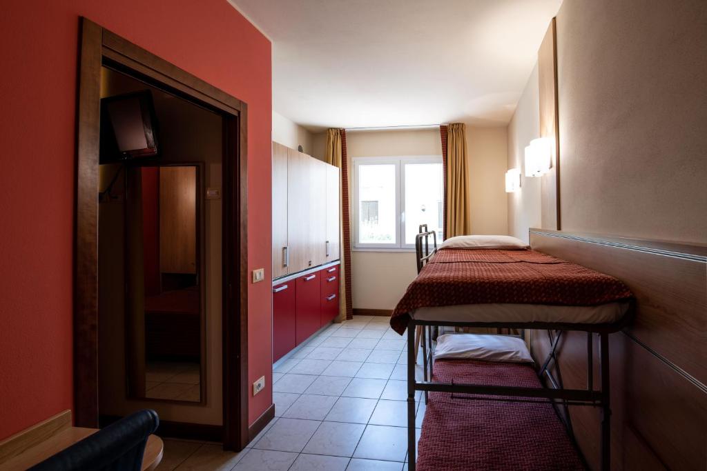 Postel nebo postele na pokoji v ubytování Hotel Mondial