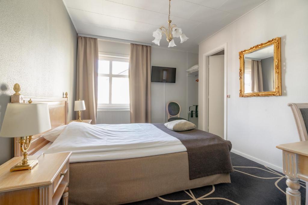 Postel nebo postele na pokoji v ubytování Hotel Dania