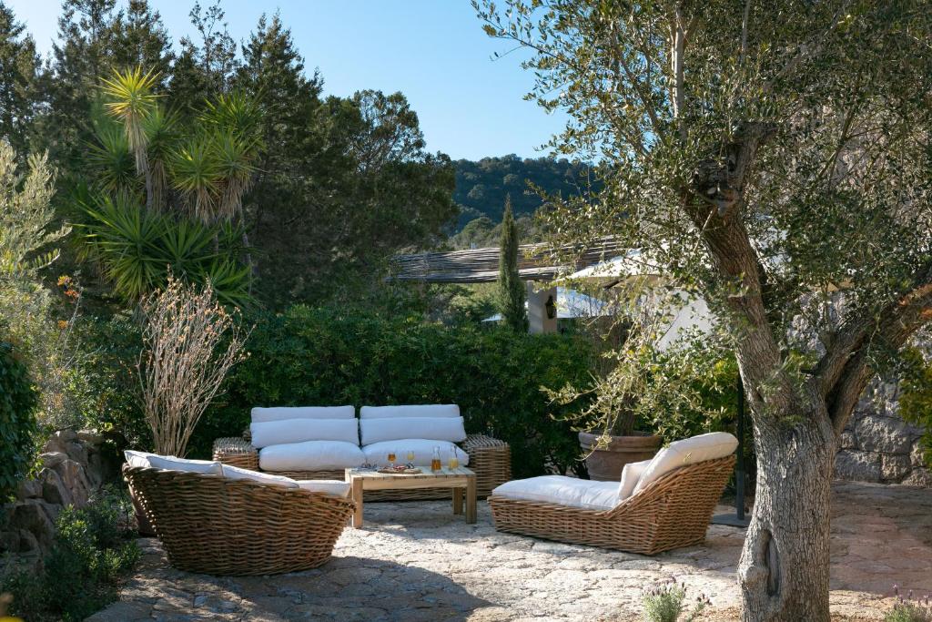 a patio with two wicker chairs and a table at Domaine Santa Giulia Palace in Porto-Vecchio