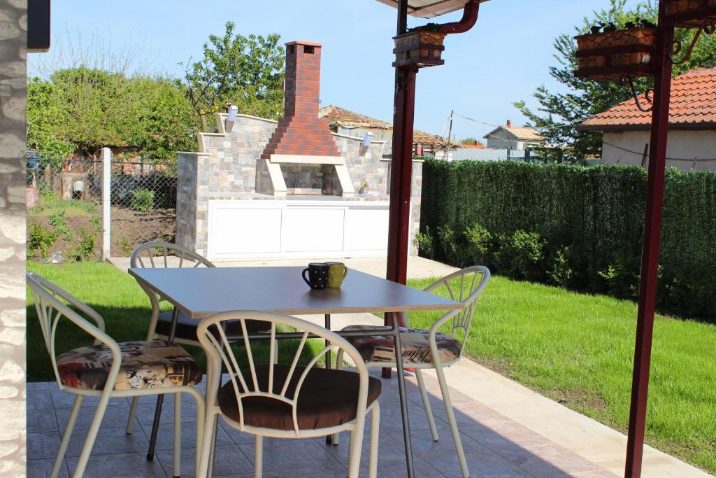 a table and chairs sitting on a patio at Guest House Valiland in Bŭlgarevo