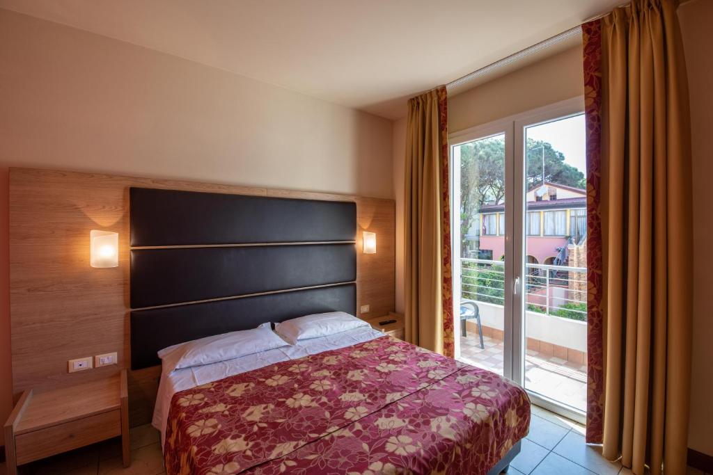 Postel nebo postele na pokoji v ubytování Hotel Mondial