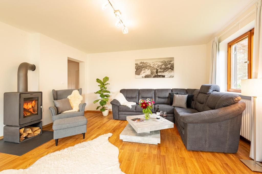 a living room with a couch and a fireplace at Ferienwohnung Jasmin in Oberstdorf