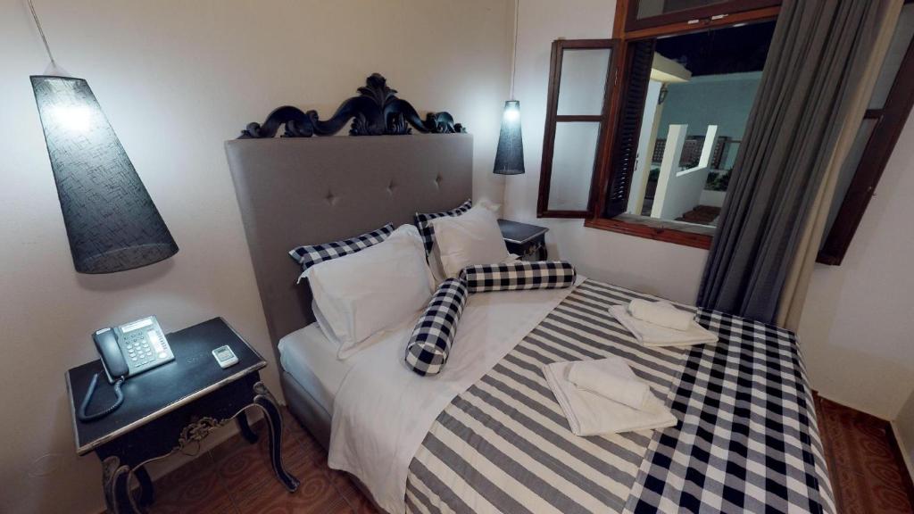 Posteľ alebo postele v izbe v ubytovaní Porto Enetiko Suites