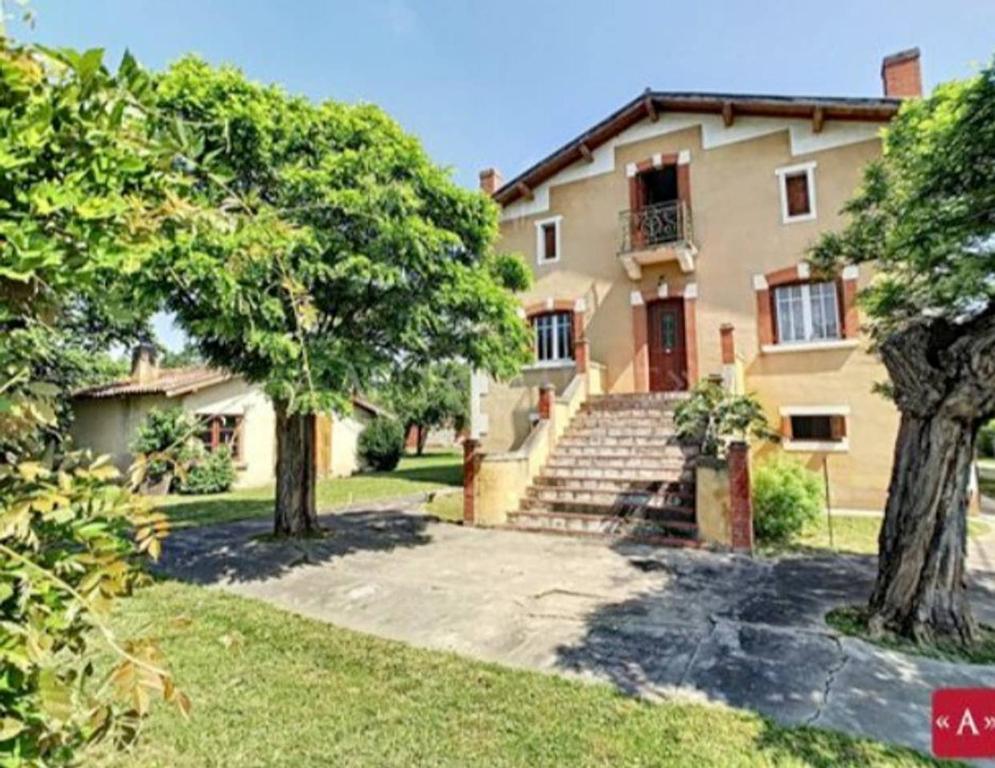 una casa grande con árboles delante de ella en Le Clos de la Gravette, en Bessières