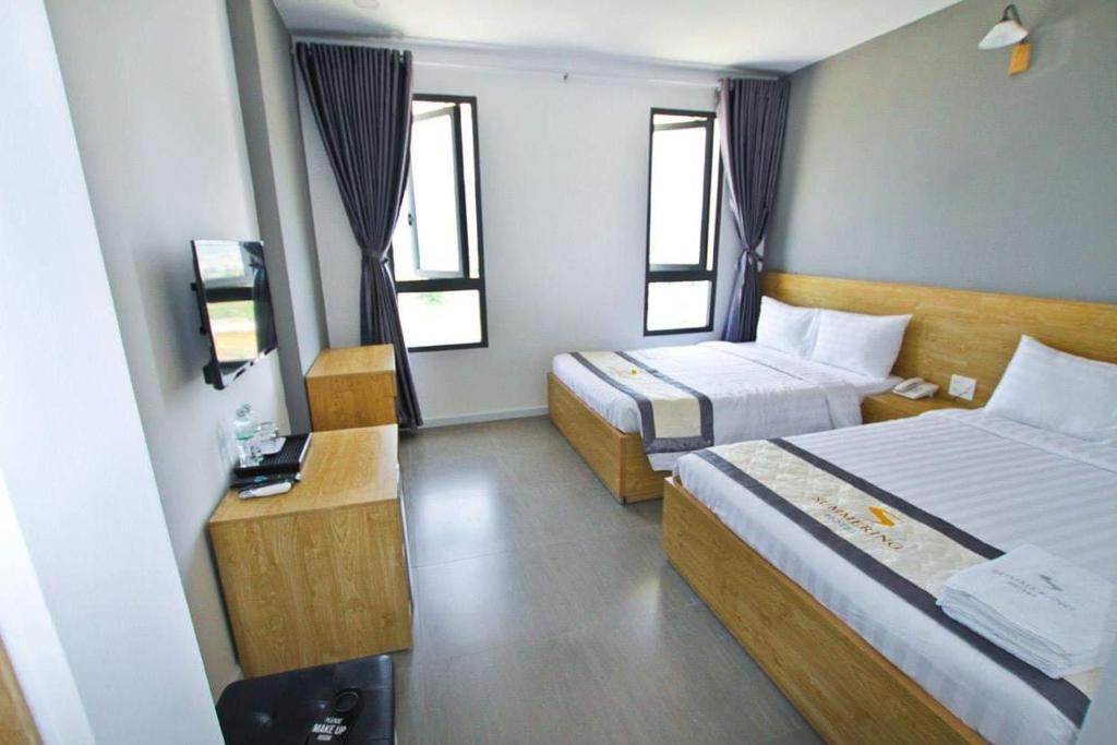 Postel nebo postele na pokoji v ubytování Summering Hotel