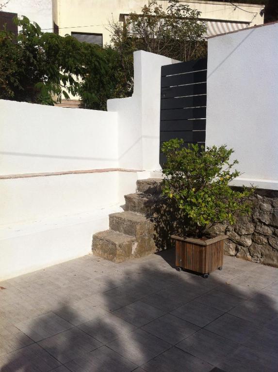 a tree in a wooden box next to a staircase at Gîte Polema in Marseille