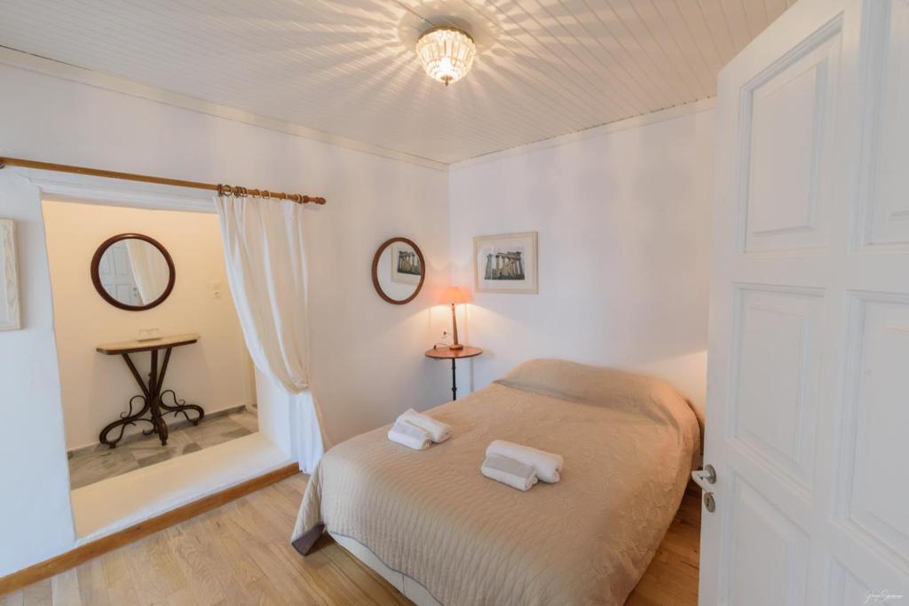 a bedroom with a bed with two towels on it at Hotel Miranda in Hydra