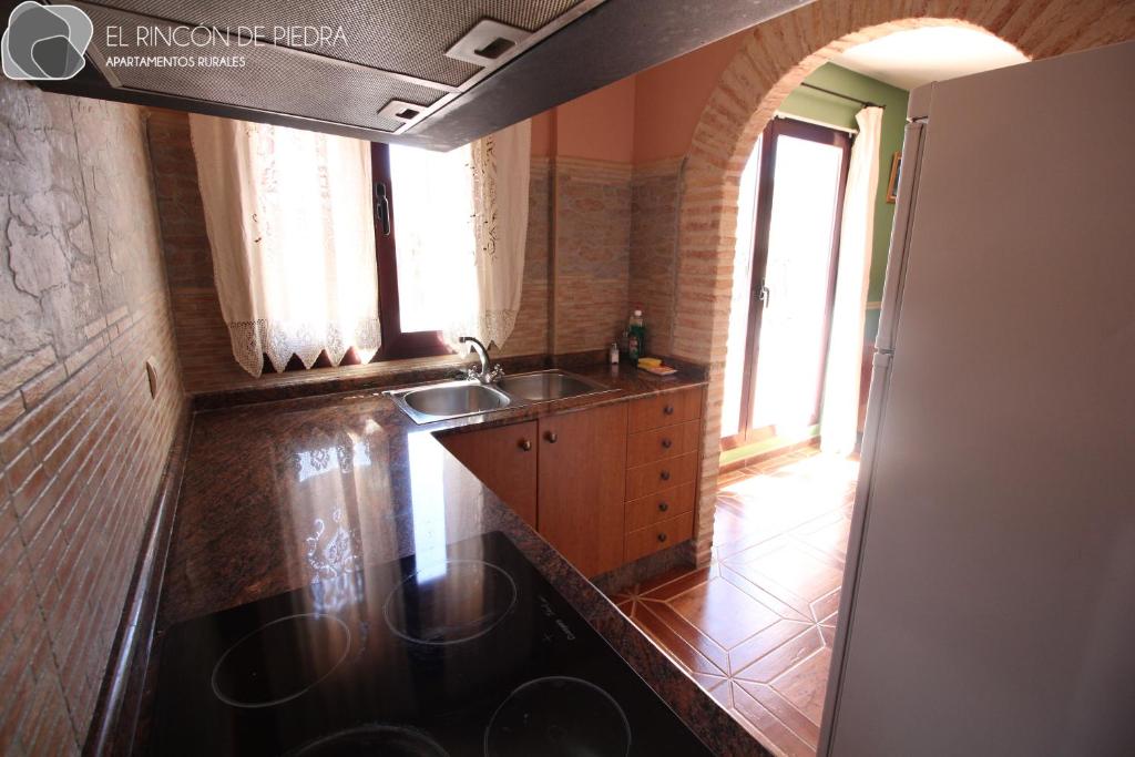 a kitchen with a sink and a counter top at El Rincon de Piedra in Enguídanos