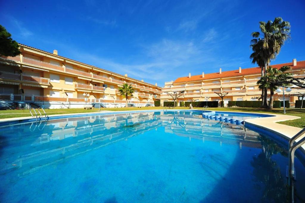 a large swimming pool in front of a building at El Castell Orange Costa in Alcossebre
