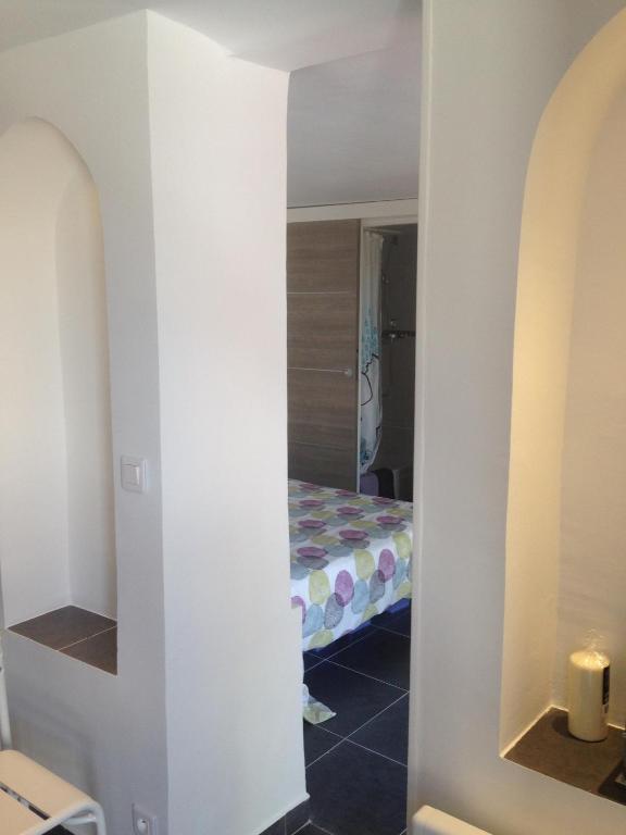 a room with a bed and a room with a mirror at Gîte Polema in Marseille