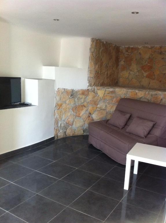 a living room with a couch and a table at Gîte Polema in Marseille