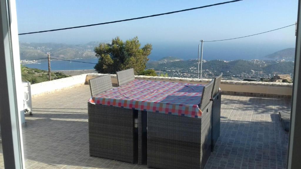 a table and chairs on a balcony with a view at Viva B&B in Anavyssos