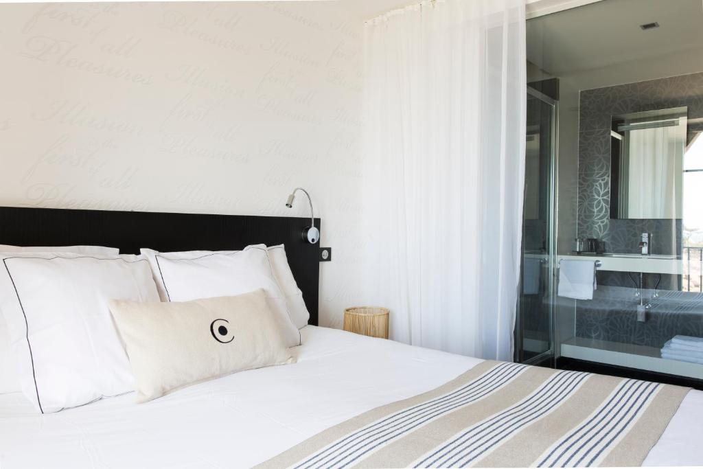 a bedroom with a bed with white pillows at Castel Beau Site in Perros-Guirec