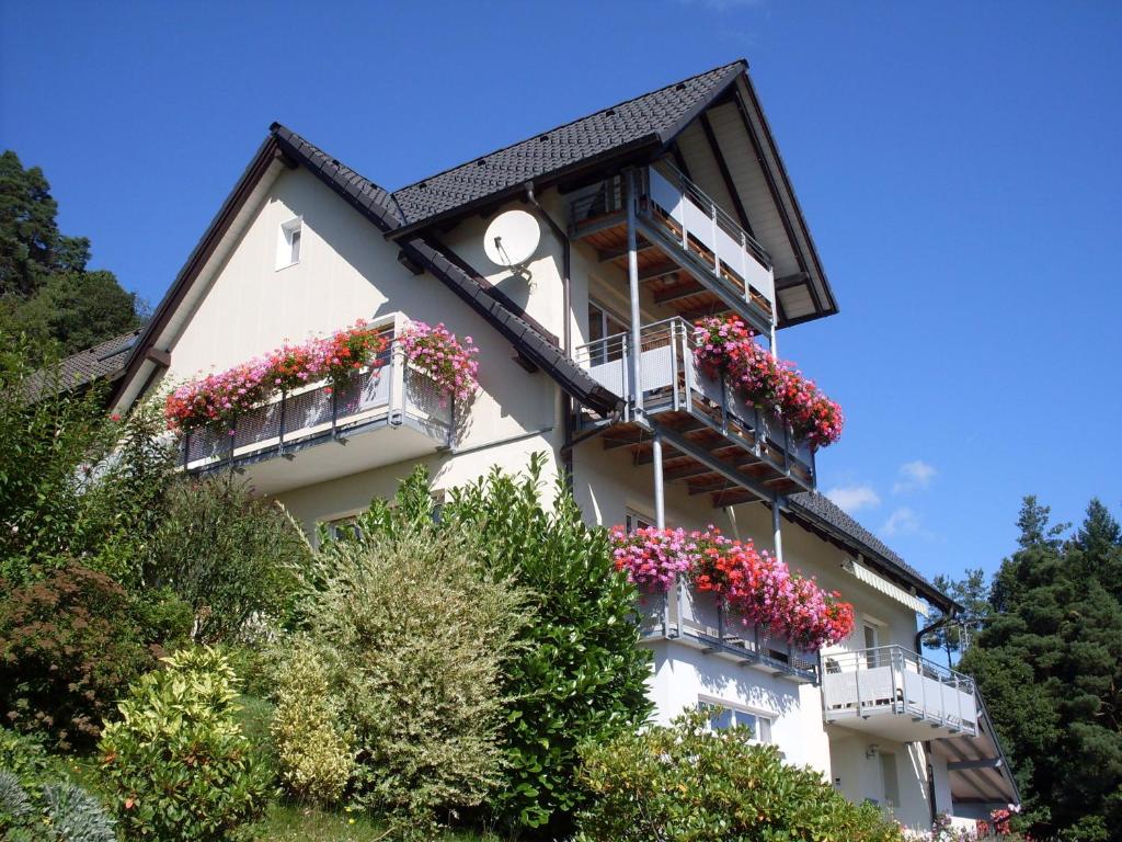a building with flower boxes on its balconies at Am Keschtewaeldele **** in Forbach