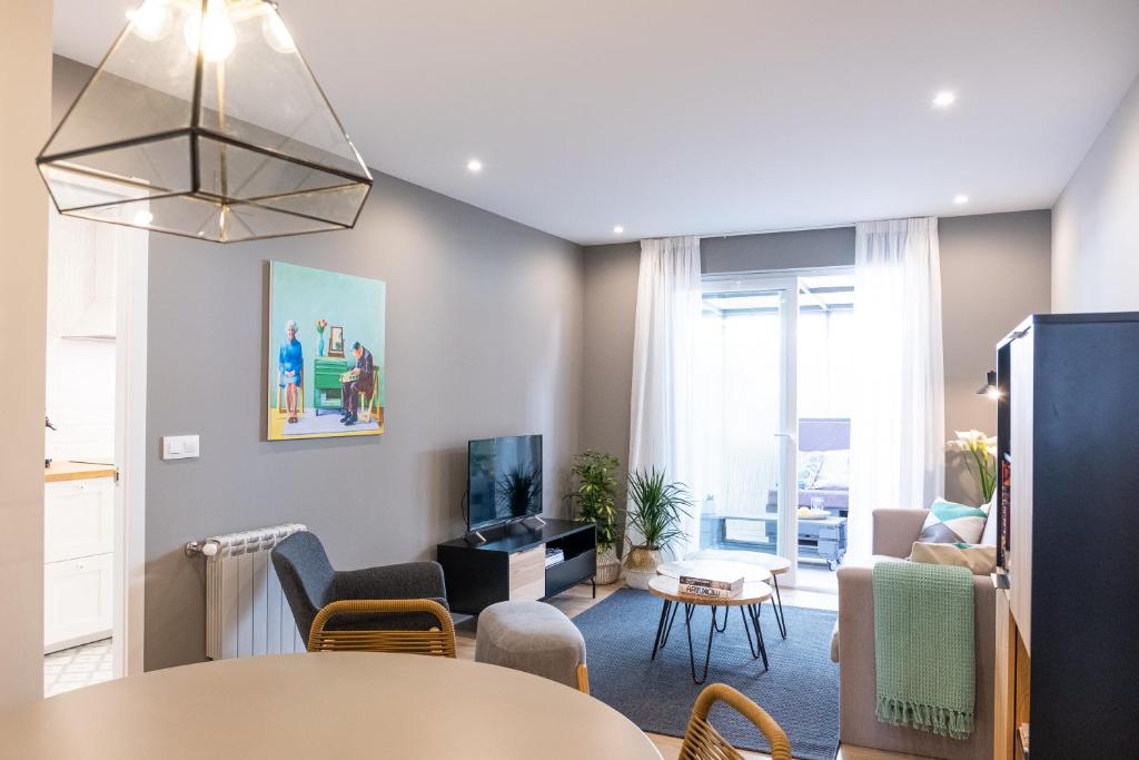 - un salon avec un canapé et une table dans l'établissement Apartamento de diseño centrico con terraza espectacular, à Saint-Jacques-de-Compostelle