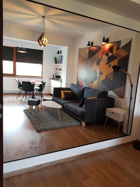 a living room with a couch and a table at Kolonaki Domus Apartment 3 in Iaşi