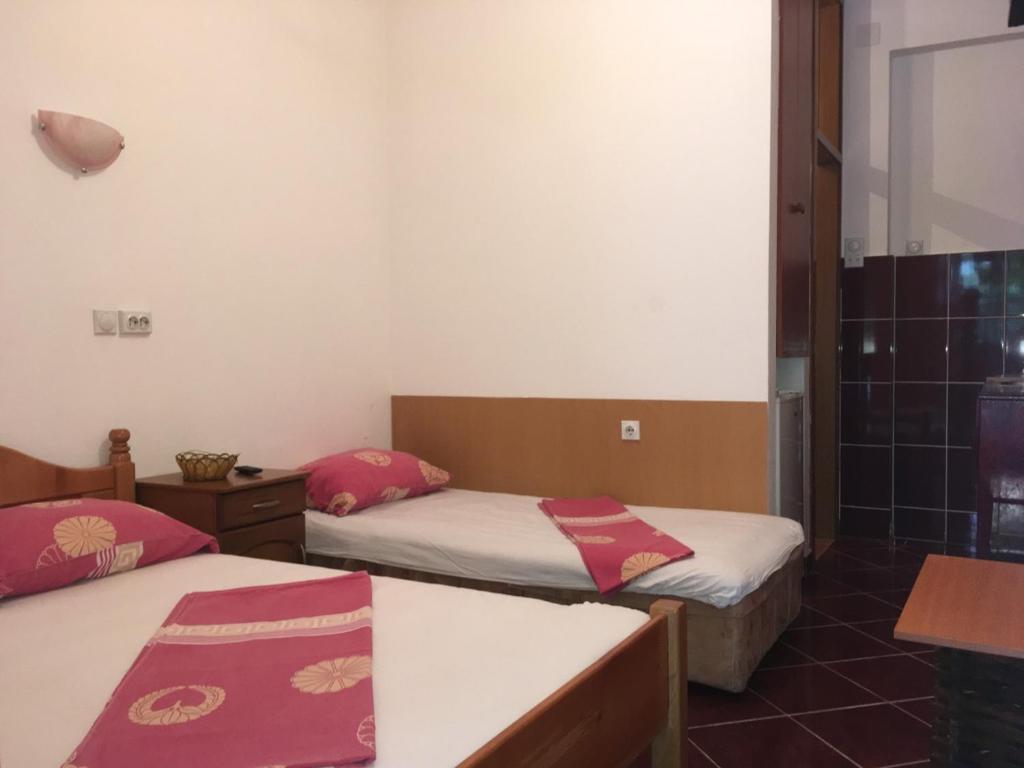 Postel nebo postele na pokoji v ubytování Apartmani Vuković