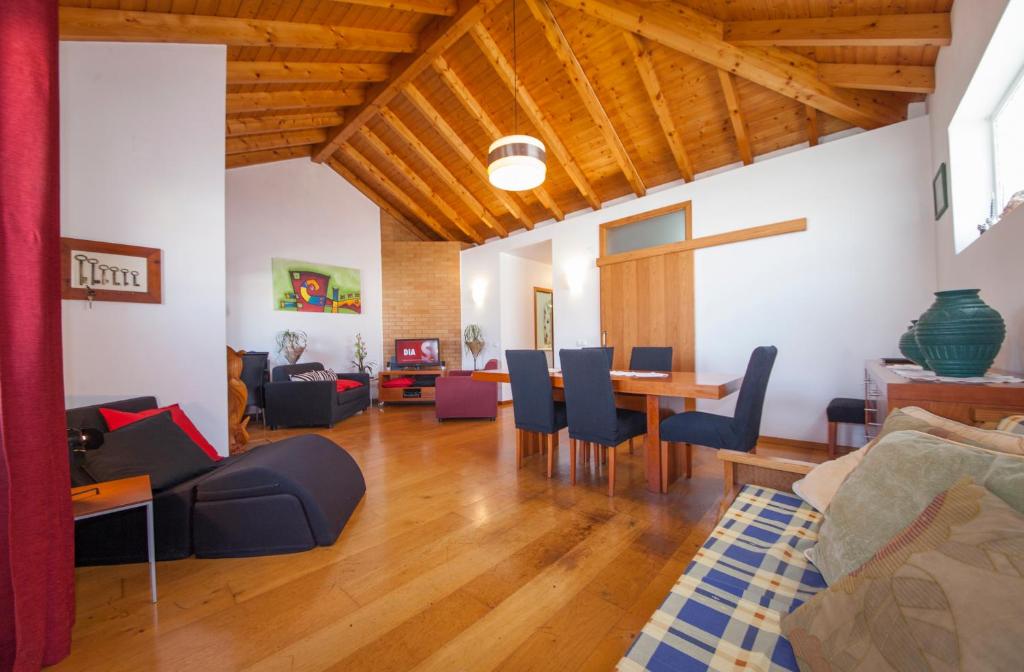 a living room with a table and chairs at Fishermans Cottage in Lagos in Lagos