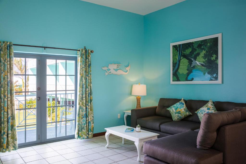a living room with a couch and a table at Grassy Flats Resort & Beach Club in Marathon
