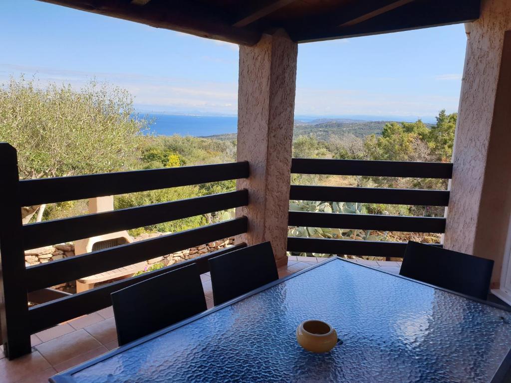 a table on the balcony of a house with a view at casabellavista in Bonifacio