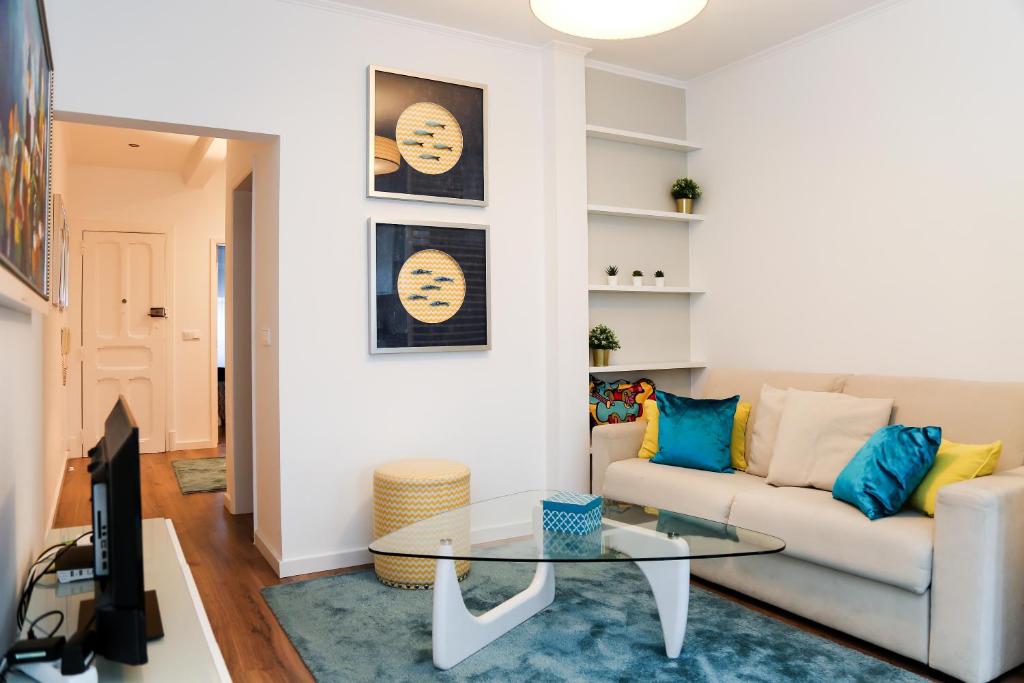 een woonkamer met een bank en een tafel bij São João Studios & Flats by Lisbon Village Apartments in Lissabon