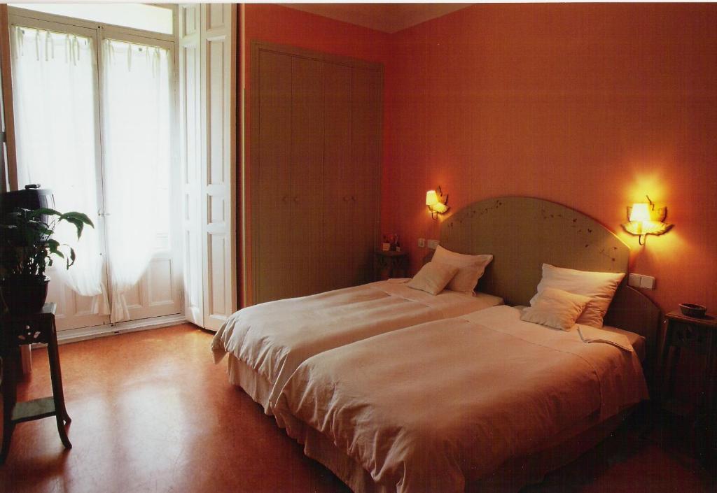 Posteľ alebo postele v izbe v ubytovaní Hostal Fornos