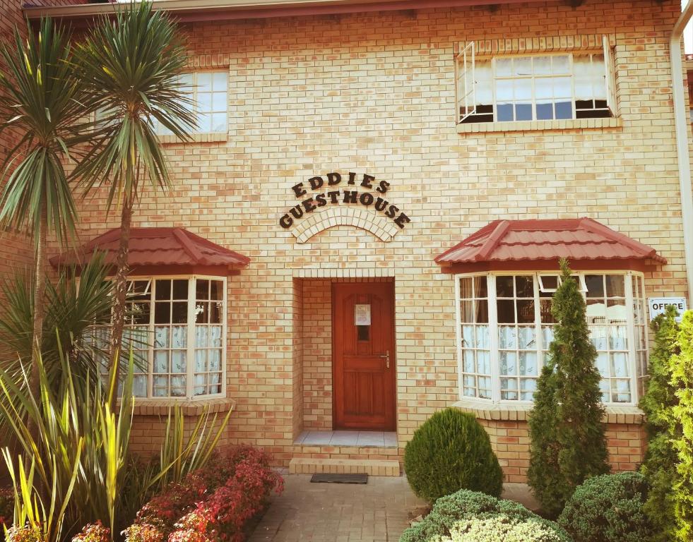 a brick building with a sign that readsagles chiropractor at Clarens Eddies Guest house in Clarens