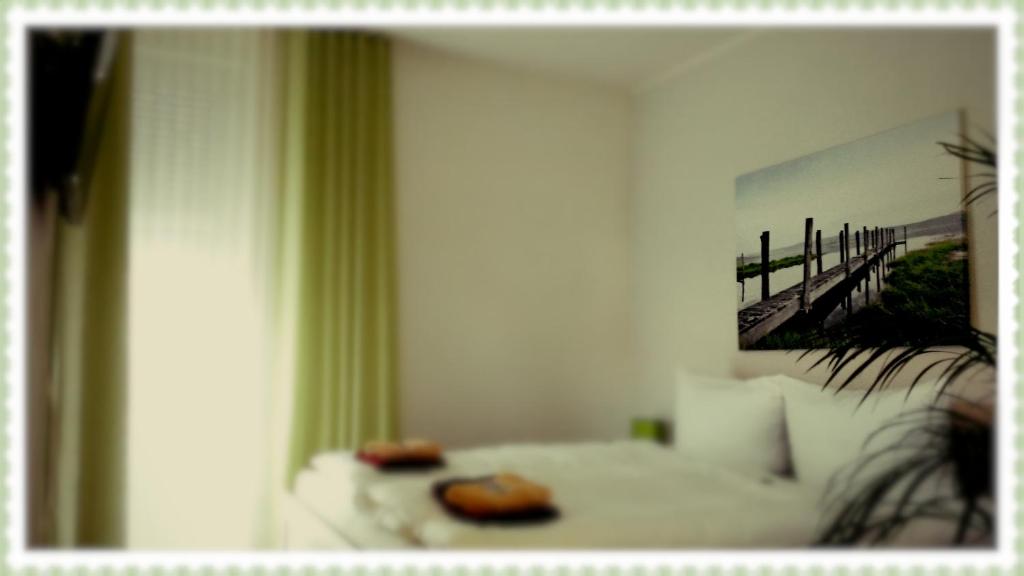 two donuts sitting on a white couch in front of a mirror at Pension Zeitlos in Potsdam