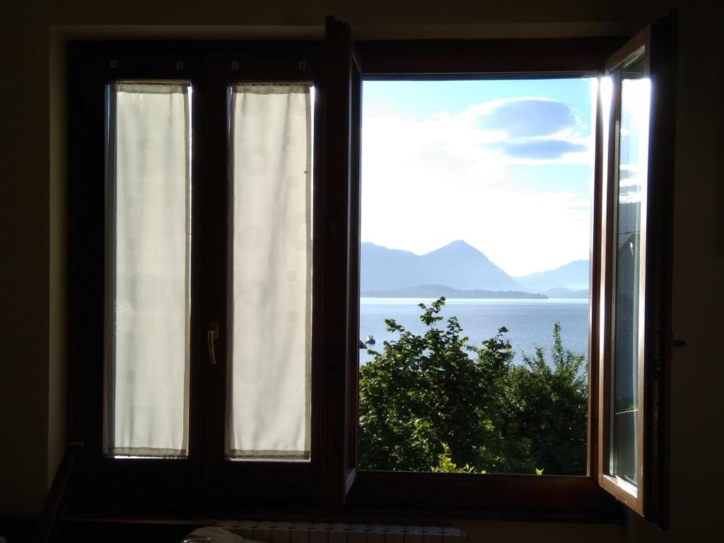 an open window with a view of the ocean at Casa Bella Vista in Baveno