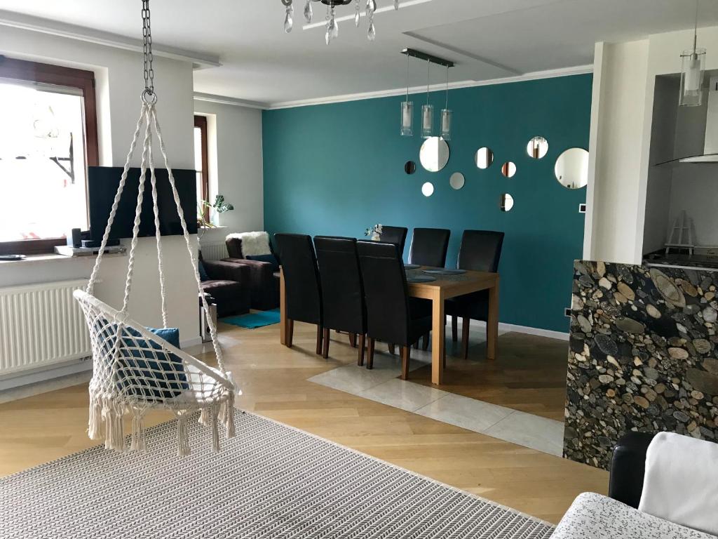 a living room with a dining room table and chairs at Stadium Apart in Warsaw