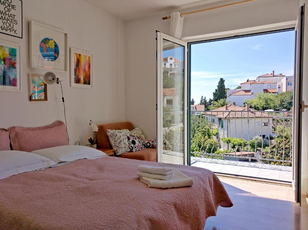 a bedroom with a bed and a large window at Lina Vranković Apartments in Hvar