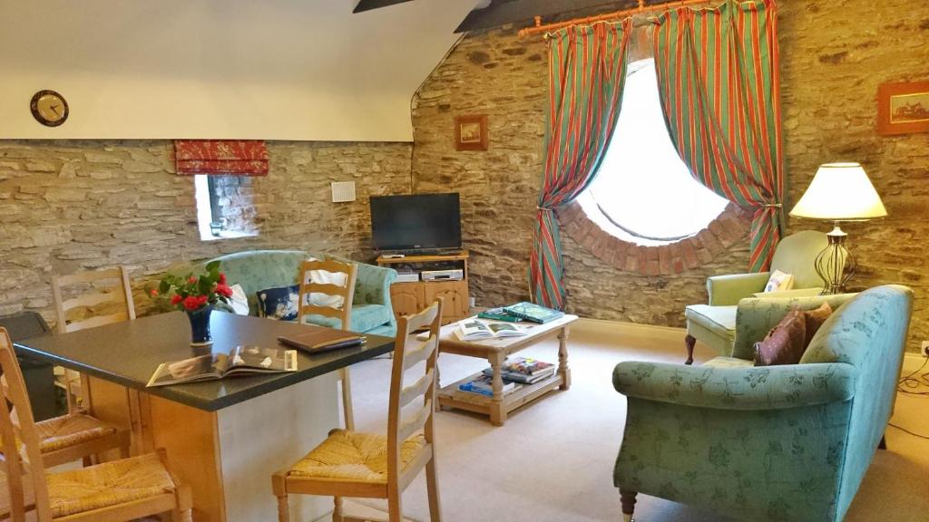 a living room with a table and chairs at Kilmokea Garden Suite in New Ross