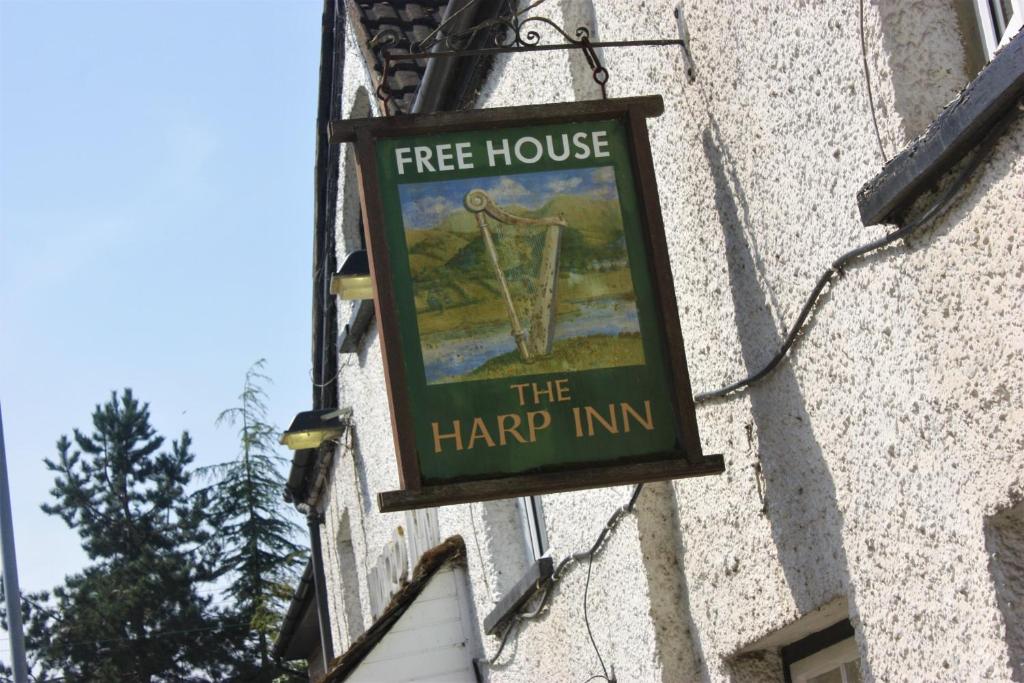 a free house sign on the side of a building at The Harp Inn in Glasbury