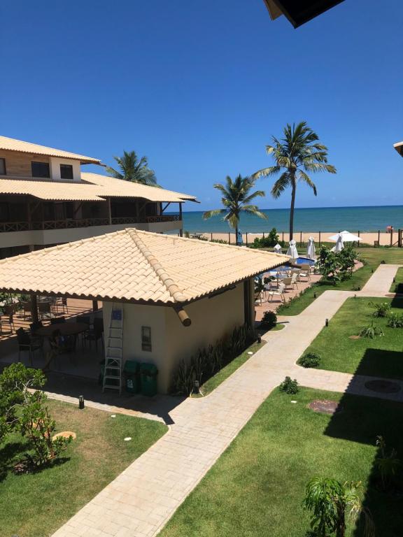 a view of the beach from the balcony of a resort at Village Itacimirim in Itacimirim