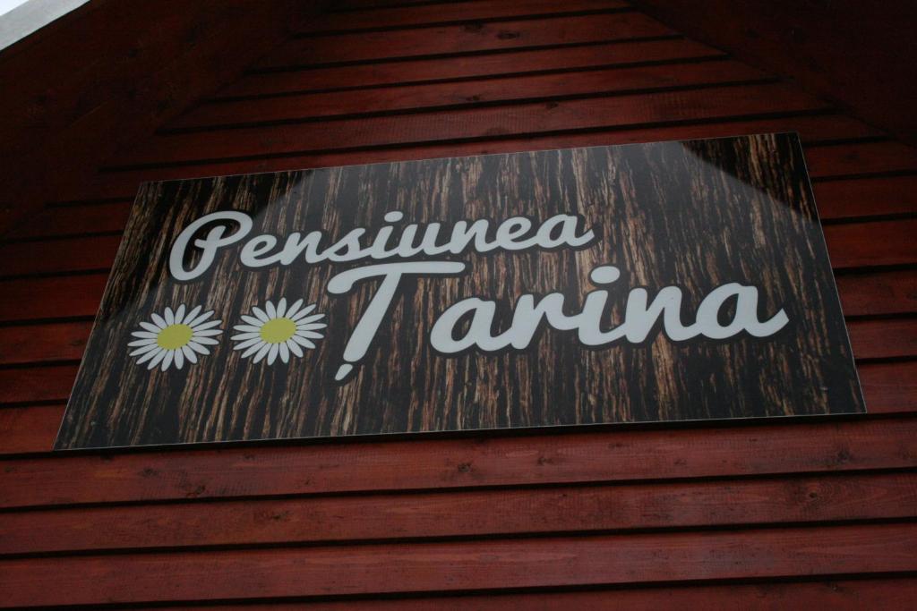 a sign on the side of a building at Pensiunea Tarina in Şuncuiuş