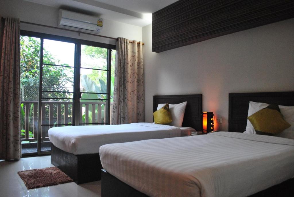 Postel nebo postele na pokoji v ubytování Kong Garden View Resort Chiang Rai