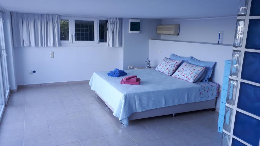 a bedroom with a bed with a purse on it at Viva B&B in Anavyssos