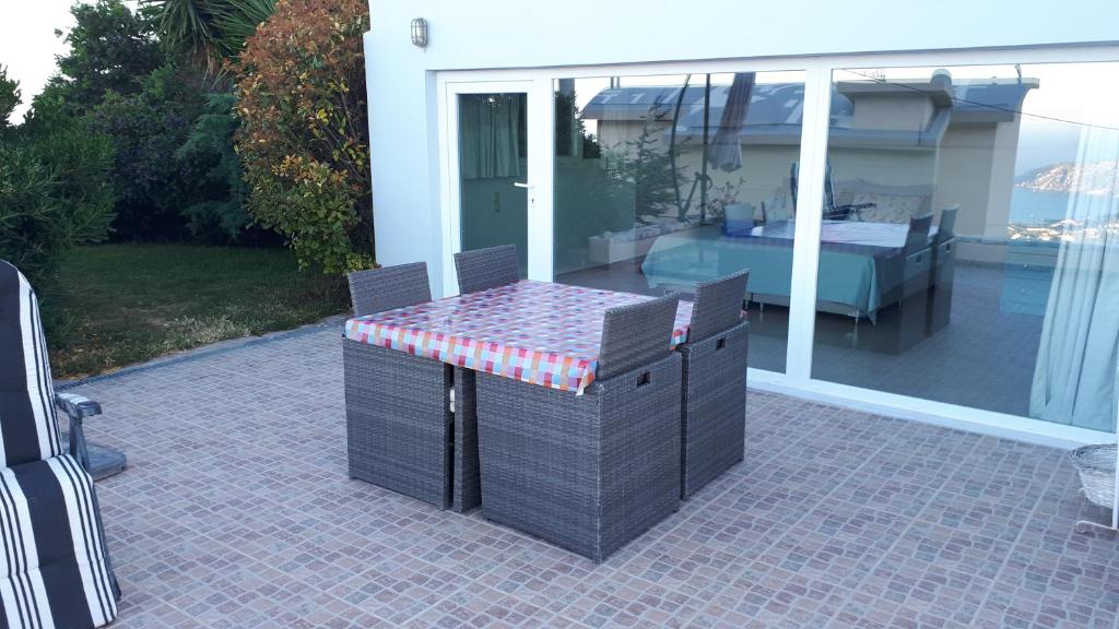 a table and chairs sitting on a patio at Viva B&B in Anavissos