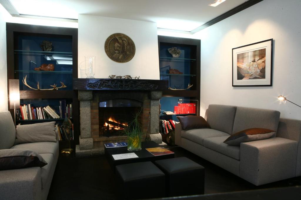 a living room with a couch and a fireplace at Le Hameau Albert 1er in Chamonix