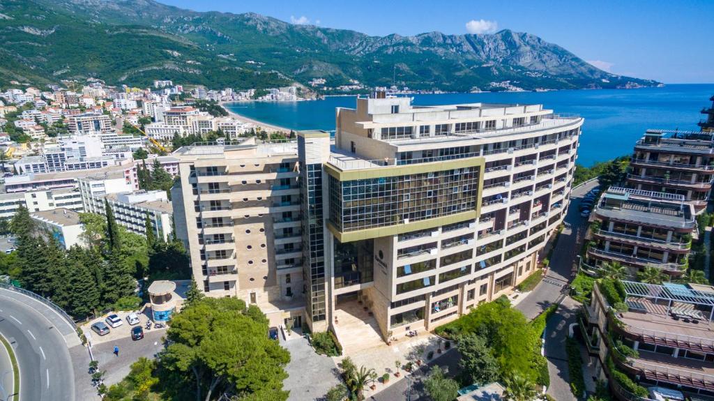an aerial view of a large building next to the water at Apartments Harmonia Colours in Budva