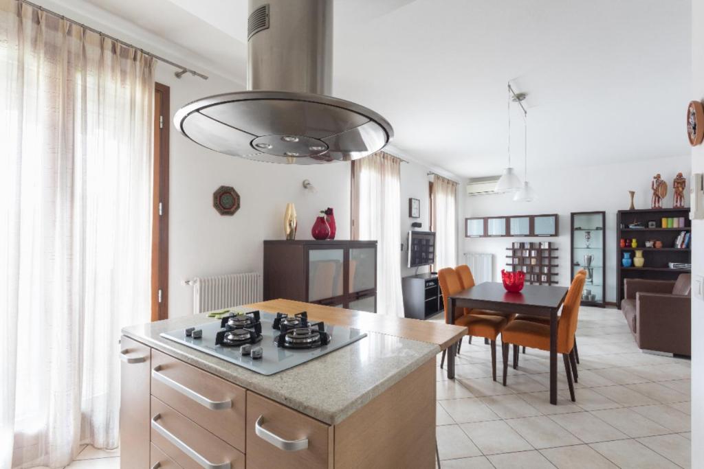 a kitchen with a stove and a table in a room at Sunrise Apartment Venice in Marghera